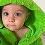 baby, child, hood, green, towel, blue_eyes, face, portrait, cute, expression, skin, eyelashes, indoor, clothing, person, young, infant, closeup, soft, adorable