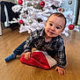 Soën participe au concours pour gagner de l'argent avec cette photo : baby, infant, child, plaid_shirt, crawling, white_christmas_tree, ornament, bauble, stocking, hardwood_floor, holiday, christmas, smile, cheeks, indoor, festive, sock, curious, portrait, floor