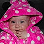 baby, child, hoodie, pink, polka_dot, cute, face, hand, fingers, blue_eyes, soft, warm_clothing, indoor, portrait, infant, smiling, cozy, couch, expression, hood