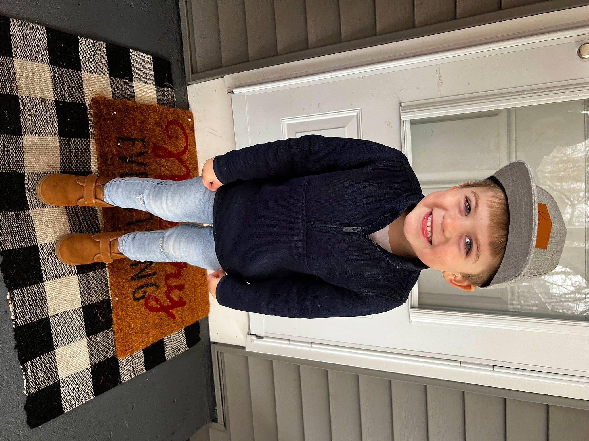 Kenny is registered to the contest to win money with this photo: comfort, elbow, flooring, hat, headwear, human_leg, joy, knee, pattern, person, rectangle, room, sleeve, smile, thigh, waist, wood