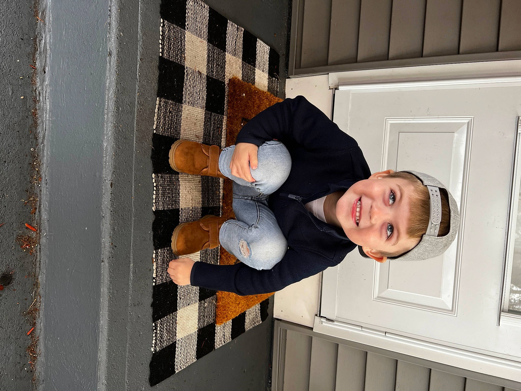 Kenny is registered to the contest to win money with this photo: child, collar, dress_shirt, elbow, happy, hat, headwear, human_leg, joy, pattern, person, room, sleeve, smile, t_shirt, thigh, toddler, window, wood