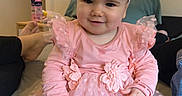 Esmée participe au concours pour gagner de l'argent avec cette photo : baby, bed, bow, child, clothing, cute, fashion, fun, happy, headband, home, indoors, infant, person, pink_dress, portrait, sitting, smile, tights, young