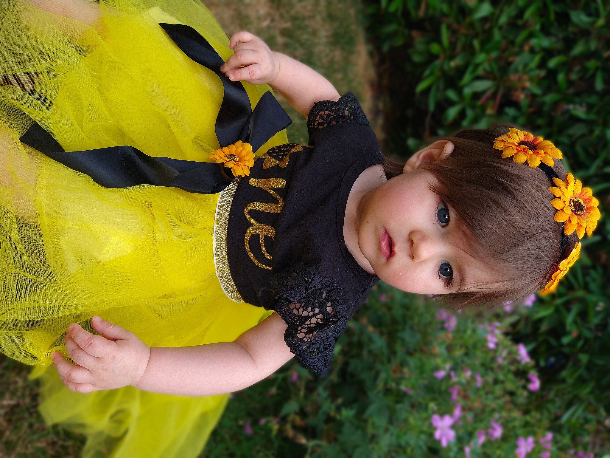 Rylee joined the competition — help win amazing prizes! dress, fashion, flash_photography, flower, flowering_plant, fun, grass, happy, leaf, meadow, natural_environment, pattern, people, people_in_nature, person, petal, plant, sunlight, toddler, vertebrate