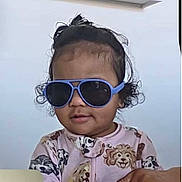 Laili Atwood joined the competition — help win amazing prizes! toddler, child, sunglasses, blue, hair, curly_hair, topknot, clothing, dog_pattern, cute, indoor, portrait, person, baby, face, expression, fashion, casual, young_child, smile