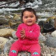 Charlotte is registered to the contest to win money with this photo: baby, child, smiling, pink_clothing, polka_dot, sitting, rocks, river, water, nature, outdoor, happy, clapping, barefoot, cute, portrait, stream, playful, infant, natural_light