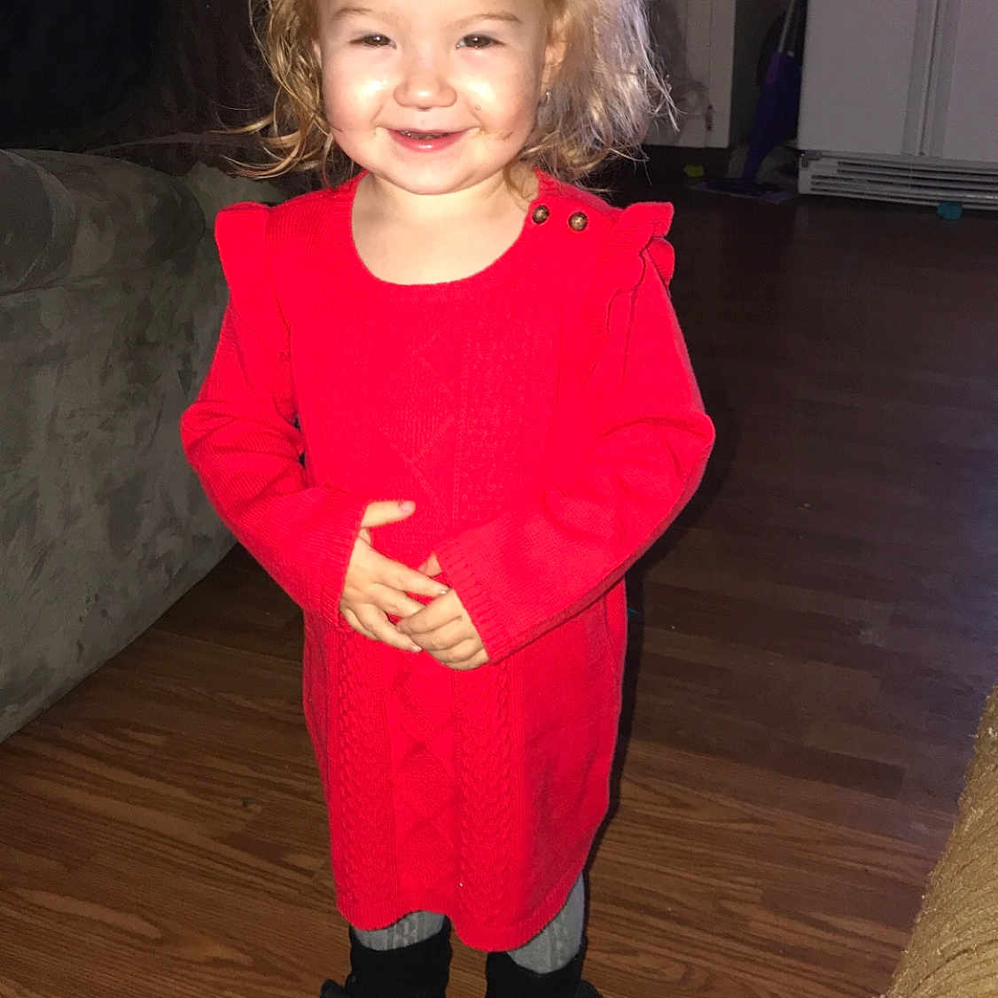 Rylie is registered to the contest to win money with this photo: child, clothing, costume, day, facial_expression, flooring, footwear, fun, girl, human_hair_color, joy, outerwear, person, product, red, shoulder, skin, smile, standing, textile