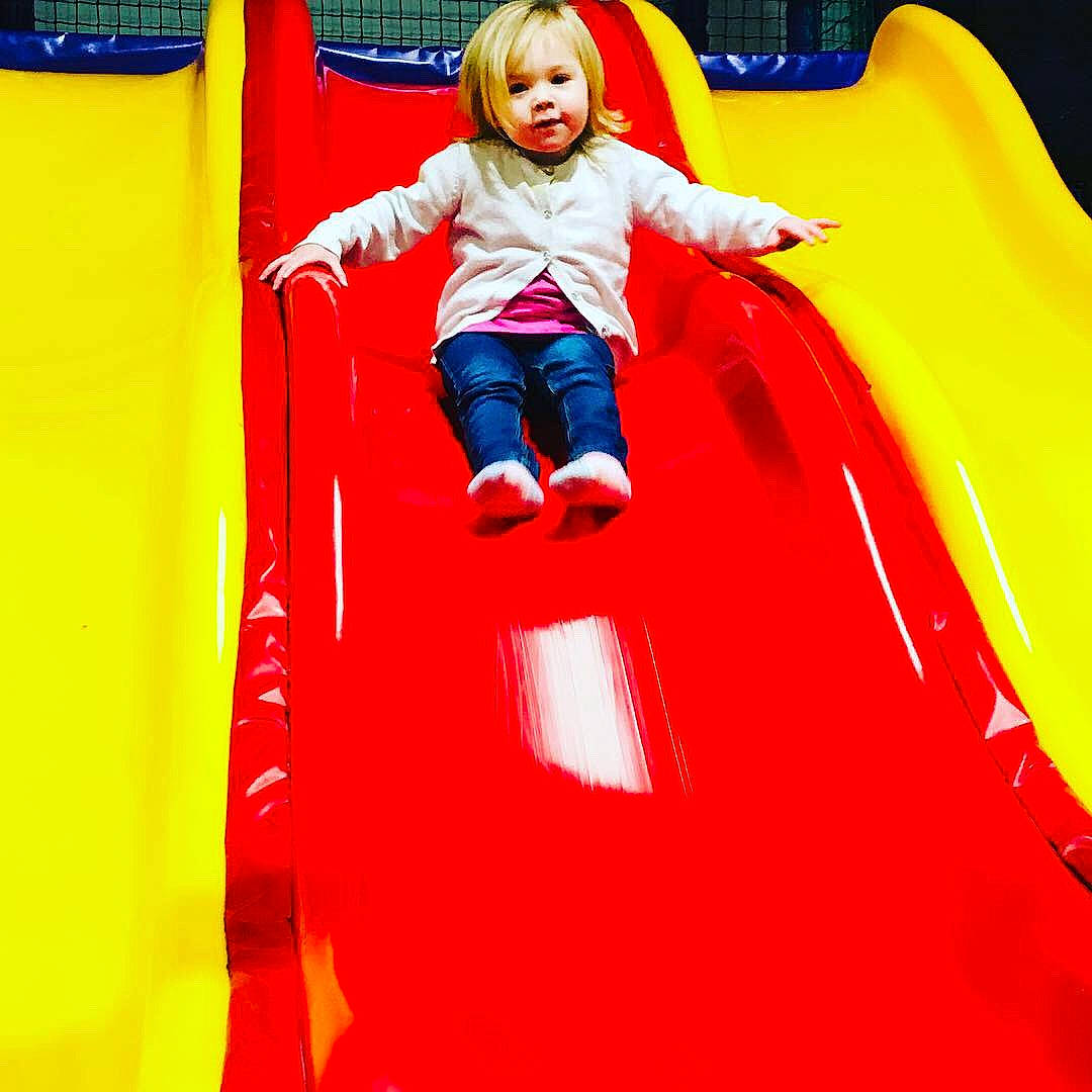 Scarlett is registered to the contest to win money with this photo: bounce_house, child, chute, fun, inflatable, leisure, outdoor_play_equipment, person, play, playground, playground_slide, public_space, recreation, red, yellow