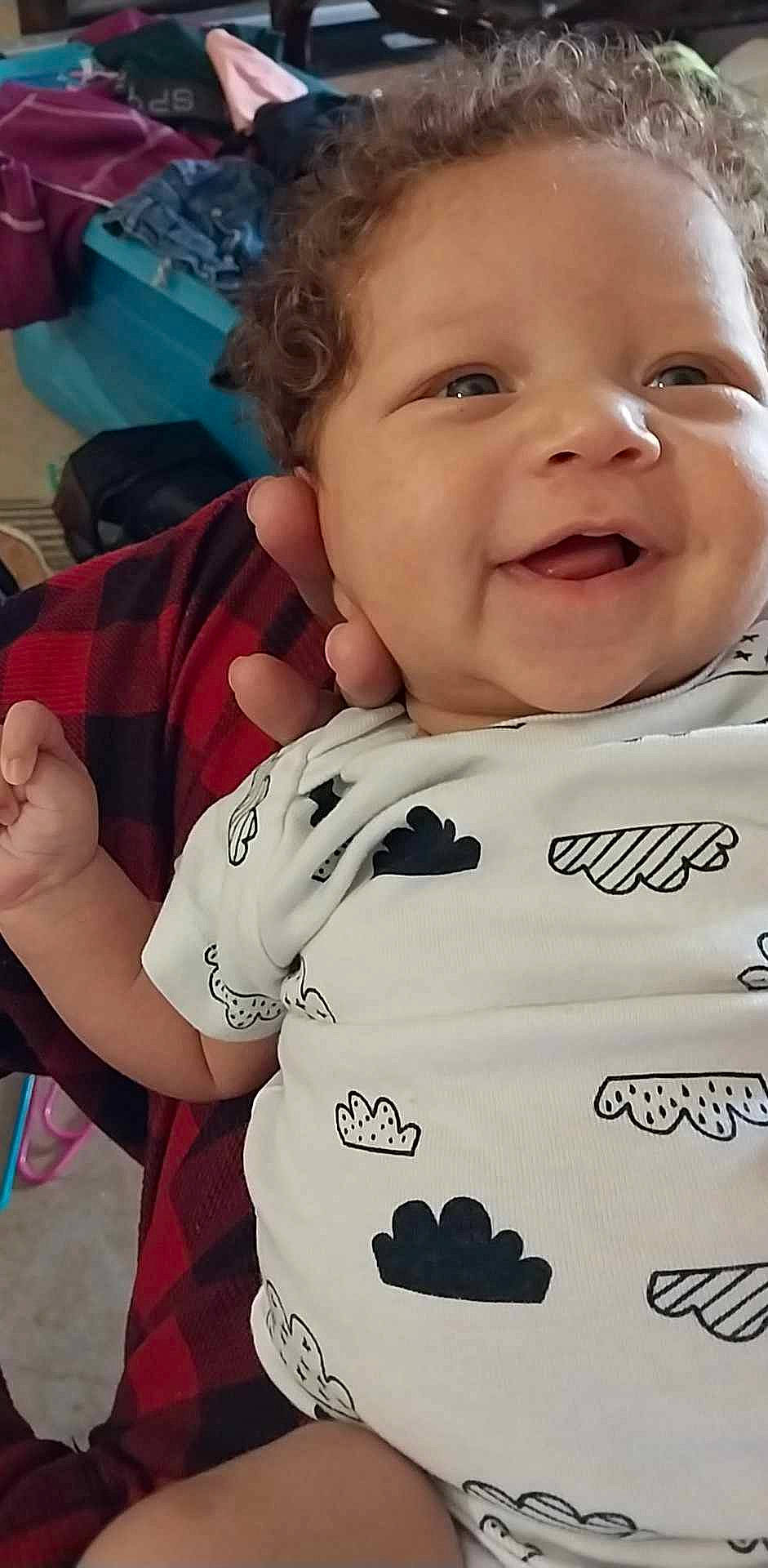 Valkyrie is registered to the contest to win money with this photo: baby, baby_toddler_clothing, cheek, child, chin, eyelash, face, finger, fun, gesture, happy, mammal, mouth, nose, person, skin, sleeve, smile, t_shirt, thumb