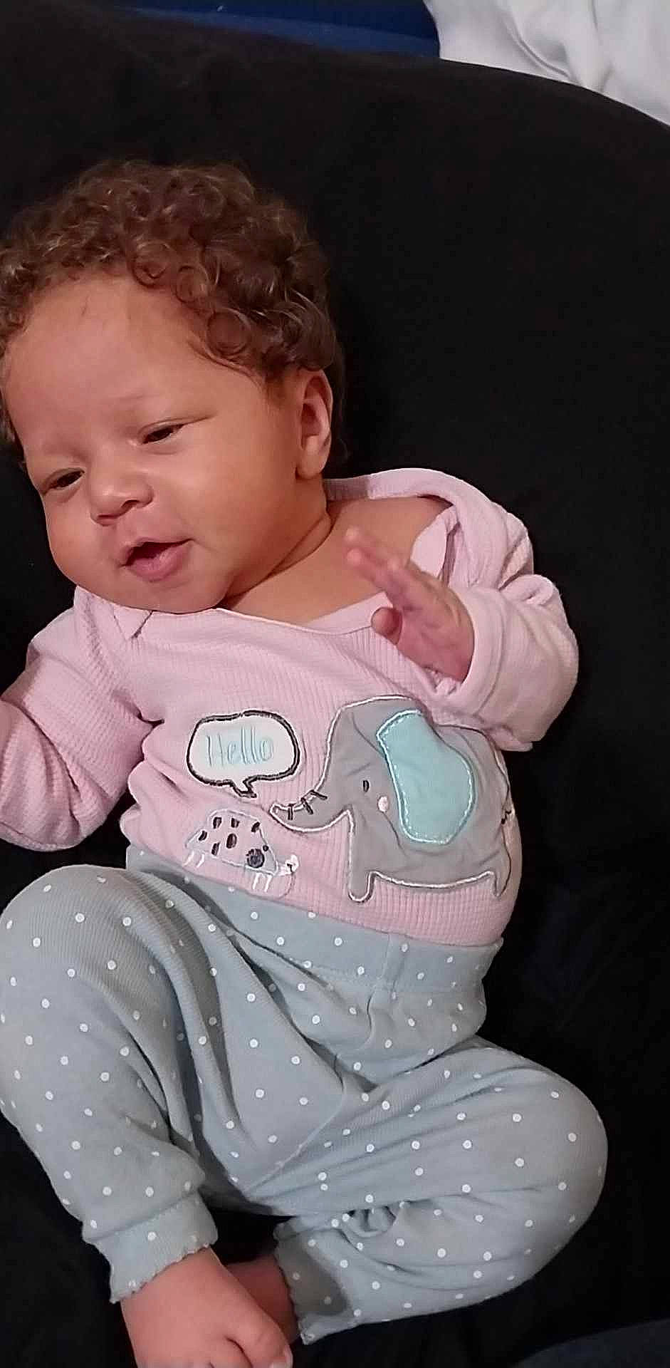 Valkyrie is registered to the contest to win money with this photo: arm, baby, baby_toddler_clothing, cheek, comfort, fun, gesture, hand, happy, human_body, lip, mouth, neck, nose, person, pink, skin, sleeve, smile, t_shirt