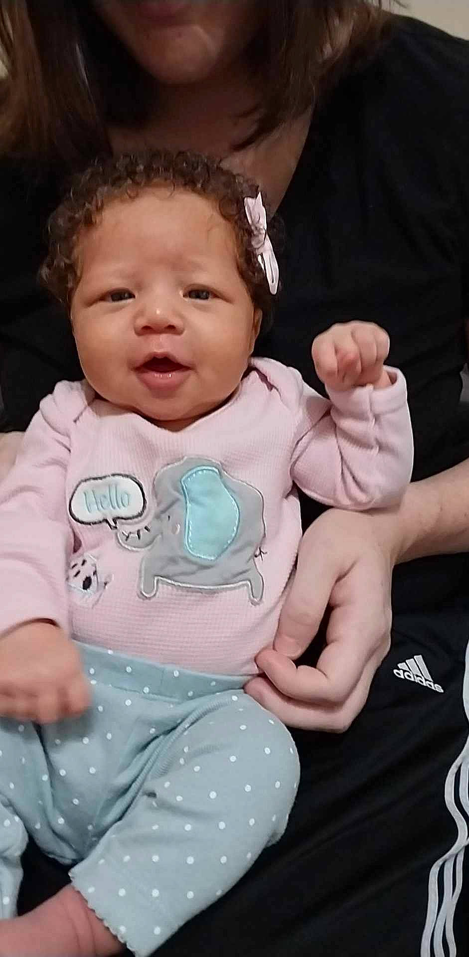 Valkyrie is registered to the contest to win money with this photo: arm, baby, baby_toddler_clothing, cheek, child, eyelash, face, finger, gesture, hairstyle, hand, happy, human_body, neck, person, pink, skin, sleeve, standing, thumb