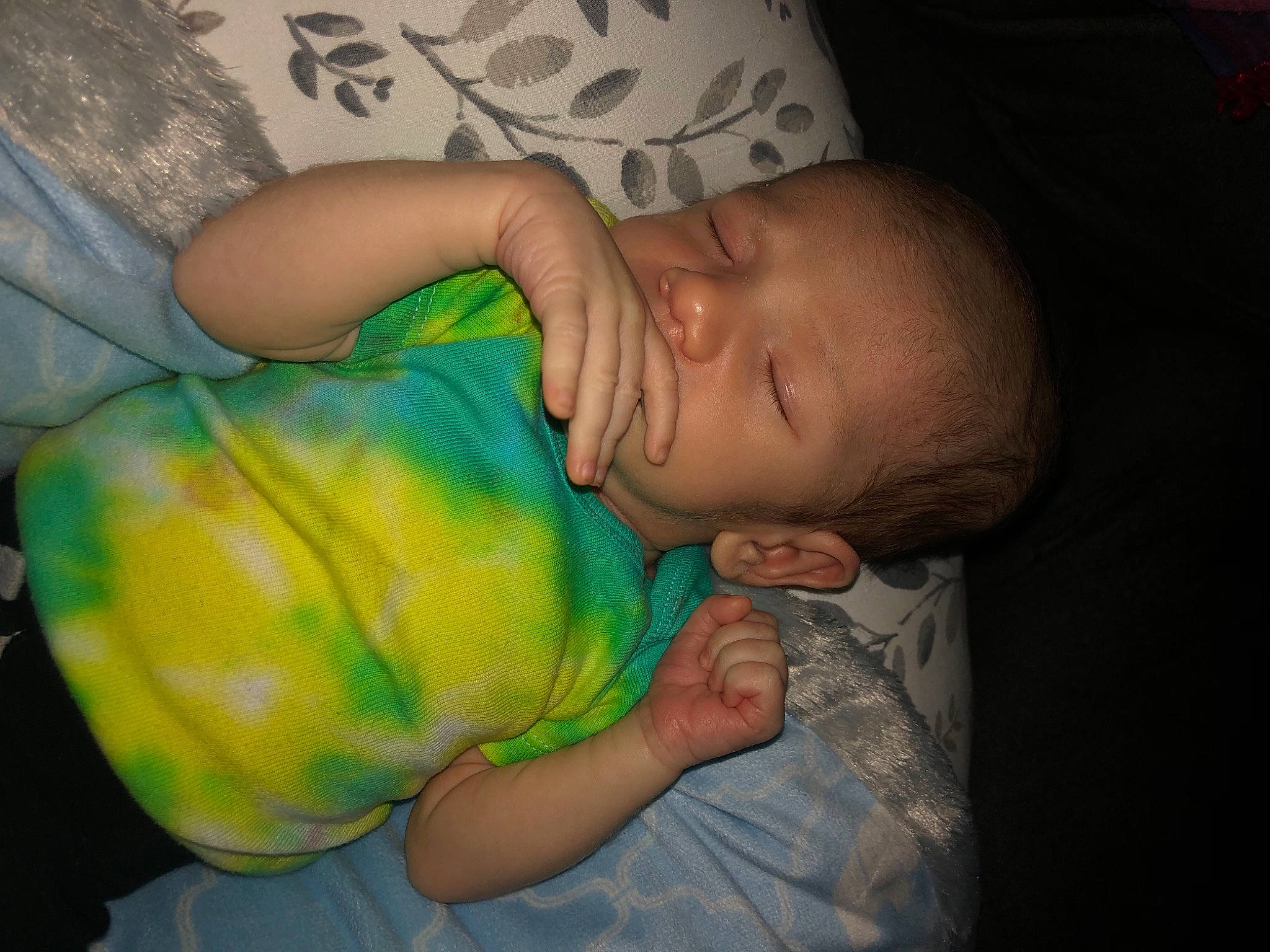 Maxwell is registered to the contest to win money with this photo: baby, baby_toddler_clothing, cheek, child, comfort, elbow, finger, gesture, hand, happy, iris, joint, mouth, nail, nose, person, sitting, skin, sleeve, thumb