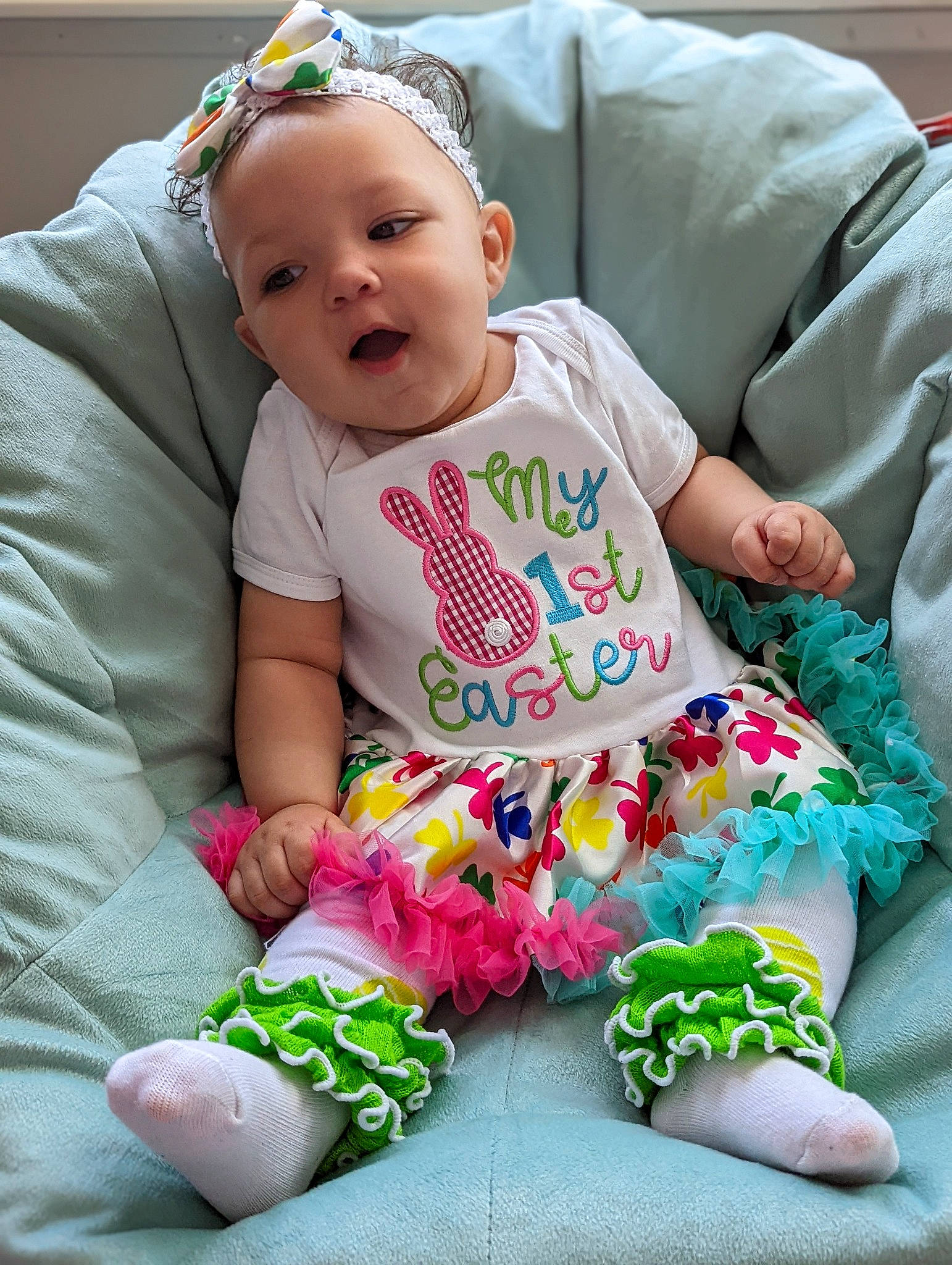 Laziah is registered to the contest to win money with this photo: baby, baby_toddler_clothing, child, comfort, face, fashion_accessory, finger, grass, green, happy, head, magenta, pattern, person, pink, product, sitting, sleeve, t_shirt, textile