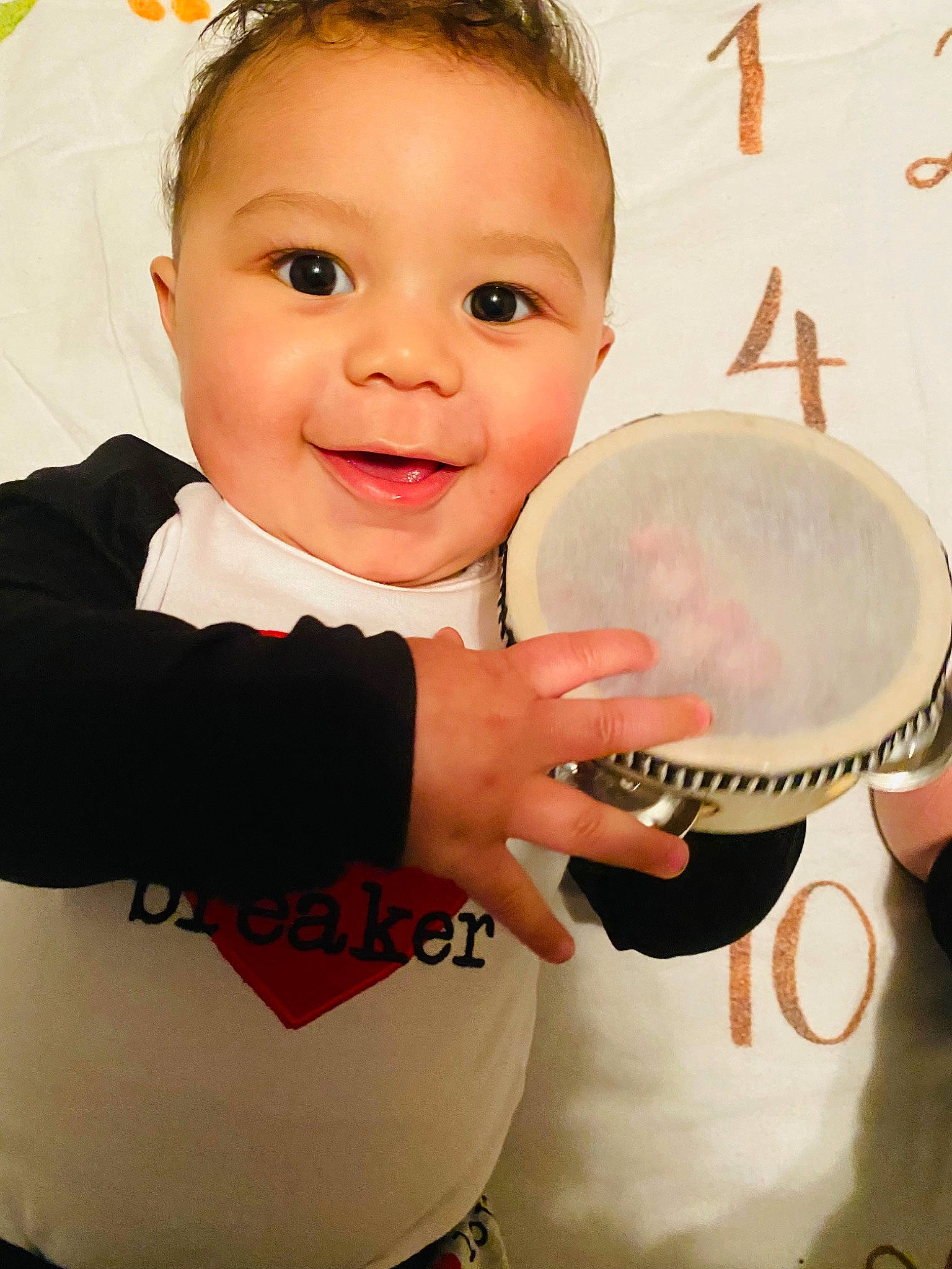 Finley joined the competition — help win amazing prizes! baby, baby_toddler_clothing, cheek, drum, face, facial_expression, finger, gesture, hairstyle, happy, head, idiophone, joy, kitchen_utensil, membranophone, musical_instrument, person, pink, sleeve, smile