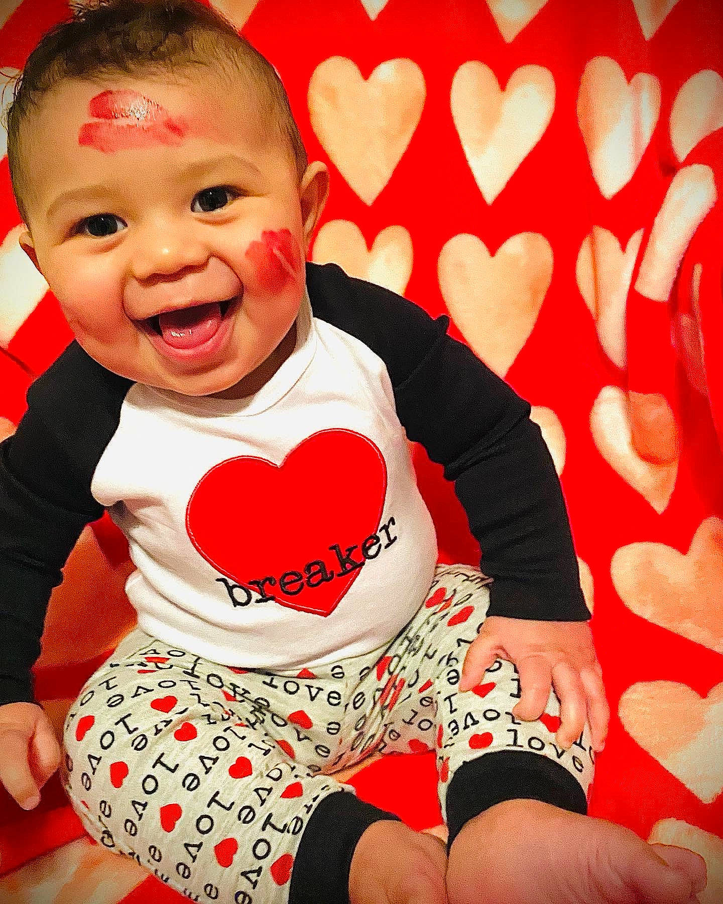 Finley is registered to the contest to win money with this photo: baby_toddler_clothing, cheek, clothing, comfort, eye, finger, fun, gesture, happy, human_body, knee, leg, person, photograph, pink, red, sleeve, smile, t_shirt, thigh