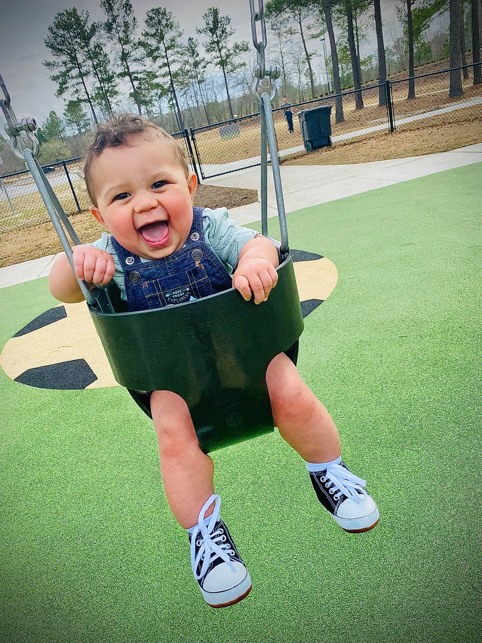 Finley is registered to the contest to win money with this photo: baby, baby_toddler_clothing, cool, fun, grass, happy, leisure, people_in_nature, person, plant, playground, recreation, shorts, sky, sleeve, smile, standing, swing, t_shirt, toddler