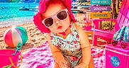 Gracie is registered to the contest to win money with this photo: baby, beach, sunglasses, sunhat, towel, sand, beach_ball, pink_bucket, inflatable_flamingo, umbrella, chair, drink, signpost, flower, summer, water, trees, vacation, child, sunshine