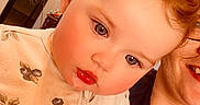 Gracie is registered to the contest to win money with this photo: adult, blue_eyes, blueberry_print, child, closeup, cozy, cream_outfit, curly_hair, face, human, indoor, person, portrait, rosy_cheeks, skin, smile, toddler, warm_lighting, young_child, zipper
