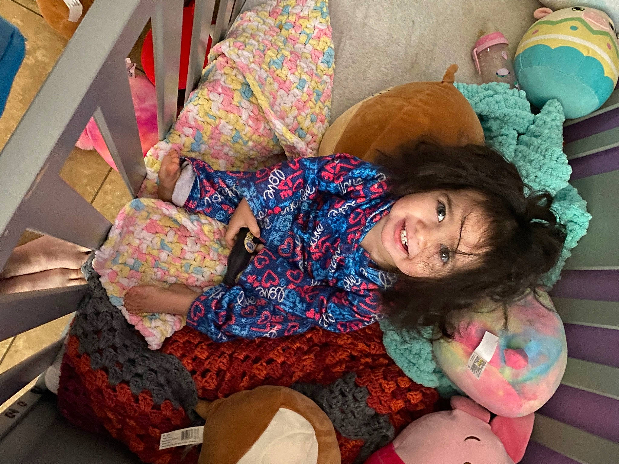 Kyla is registered to the contest to win money with this photo: child, comfort, couch, event, fun, happy, human_leg, joy, knee, lap, leisure, linens, pattern, person, pillow, room, sitting, smile, sock, textile