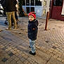 Abel participe au concours pour gagner de l'argent avec cette photo : adult, beanie, boots, boy, candid, child, coat, cobblestone, festive, holiday_lights, jeans, kid, night, pedestrian, portrait, red_hat, street, stroller, walking, winter_clothing
