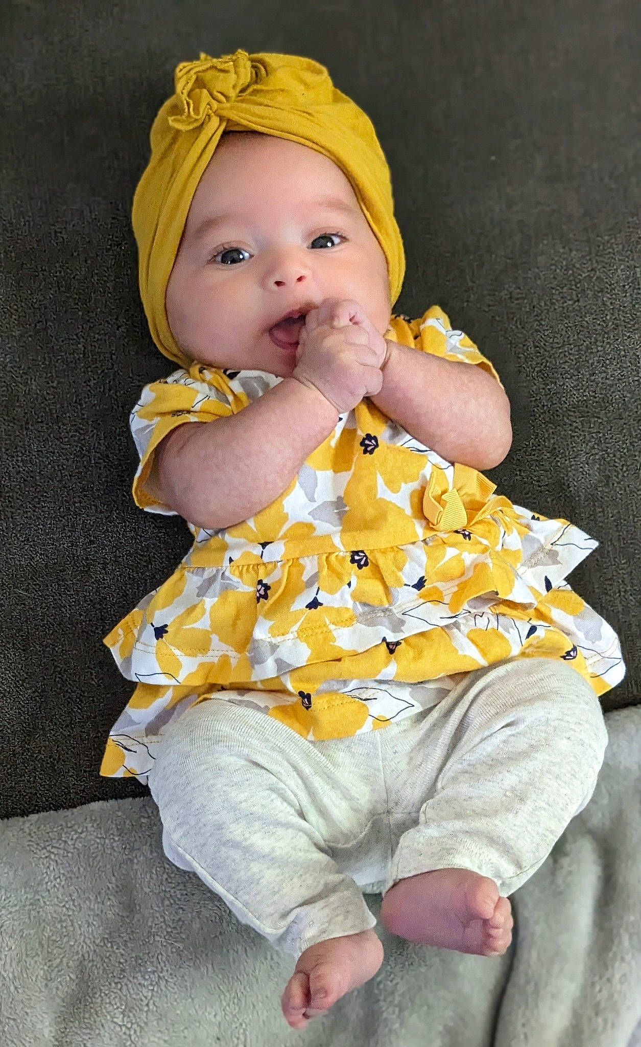 Cecilia is registered to the contest to win money with this photo: baby, baby_products, baby_toddler_clothing, cheek, child, comfort, dress, eye, face, fashion_accessory, fun, head, human_body, infant_bodysuit, nightwear, pattern, person, sitting, skin, sleeve
