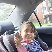 Samar is registered to the contest to win money with this photo: blue_dress, car, car_seat, casual, child, curly_hair, daylight, face, hair, indoors, person, pink_clothing, portrait, residential_building, seat, sitting, smile, vehicle_interior, window, young_child