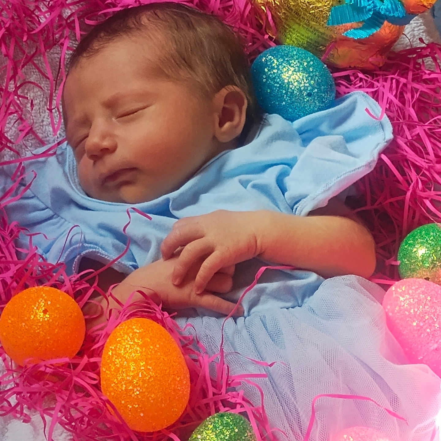 Meadow joined the competition — help win amazing prizes! baby, newborn, sleeping, blue_clothing, pink_shredded_paper, easter_eggs, glitter, orange_eggs, green_eggs, blue_egg, golden_bunny, chocolate_bunny, festive, holiday, cute, infant, peaceful, soft_texture, portrait, indoor
