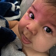Carlos is registered to the contest to win money with this photo: baby, face, blanket, child, curious, cute, closeup, expression, eyelashes, indoors, infant, looking, mouth, nostrils, person, portrait, skin, soft, tongue, young