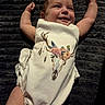 Kali is registered to the contest to win money with this photo: baby, smile, infant, clothing, blanket, arm, hand, face, portrait, happy, lying_down, baby_girl, raised_arms, text_overlay, timestamp, device_watermark, indoor, cute, fabric, skin