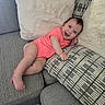 baby, child, clothing, couch, cozy, cute, fabric, furniture, happy, home, indoor, infant, person, pillows, portrait, relaxing, sitting, skin, smiling, toddler