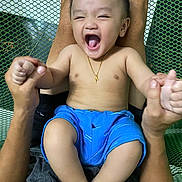 Steven joined the competition — help win amazing prizes! baby, child, smiling, laughing, blue_shorts, gold_necklace, cross, hands, adult, mesh_background, happy, bare_chest, person, skin, legs, indoors, holding, joyful, playful, portrait