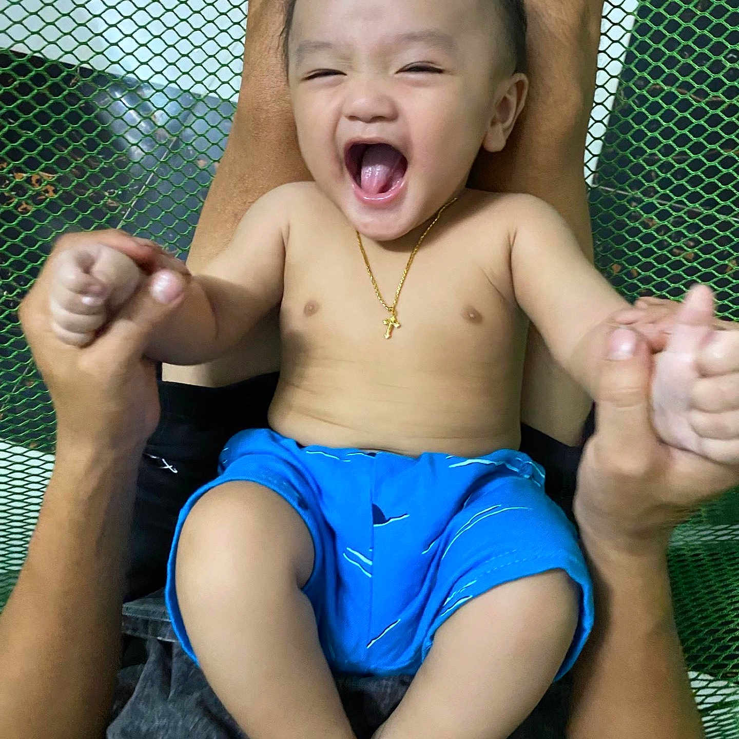 Steven joined the competition — help win amazing prizes! adult, baby, bare_chest, blue_shorts, child, cross, gold_necklace, hands, happy, holding, indoors, joyful, laughing, legs, mesh_background, person, playful, portrait, skin, smiling