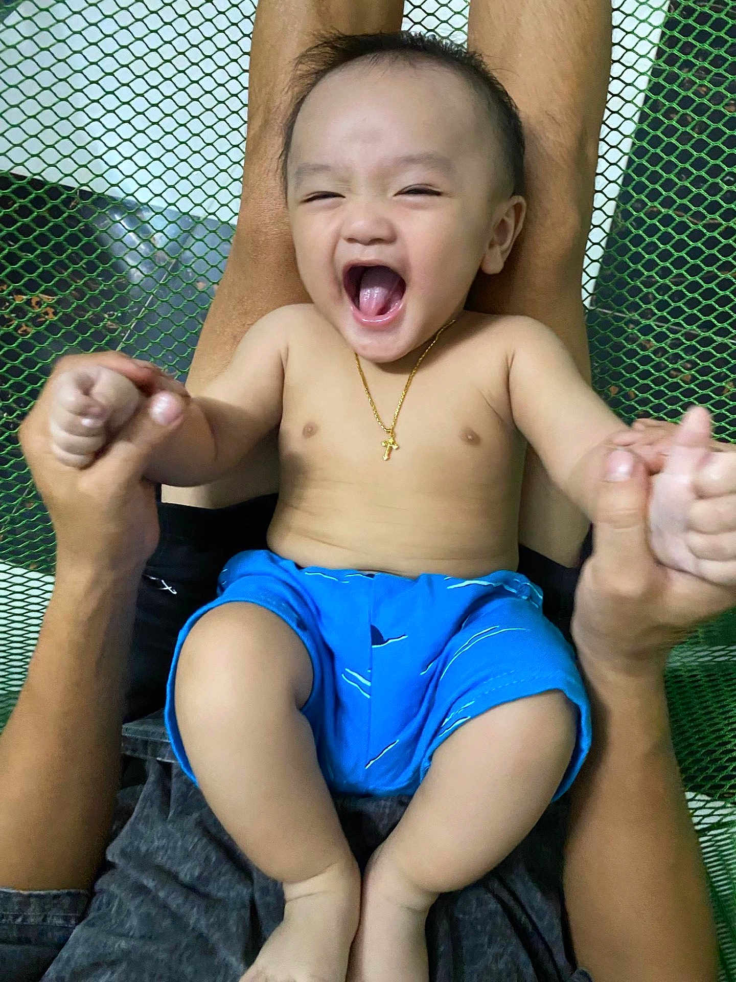 Steven joined the competition — help win amazing prizes! baby, child, smiling, laughing, blue_shorts, gold_necklace, cross, hands, adult, mesh_background, happy, bare_chest, person, skin, legs, indoors, holding, joyful, playful, portrait