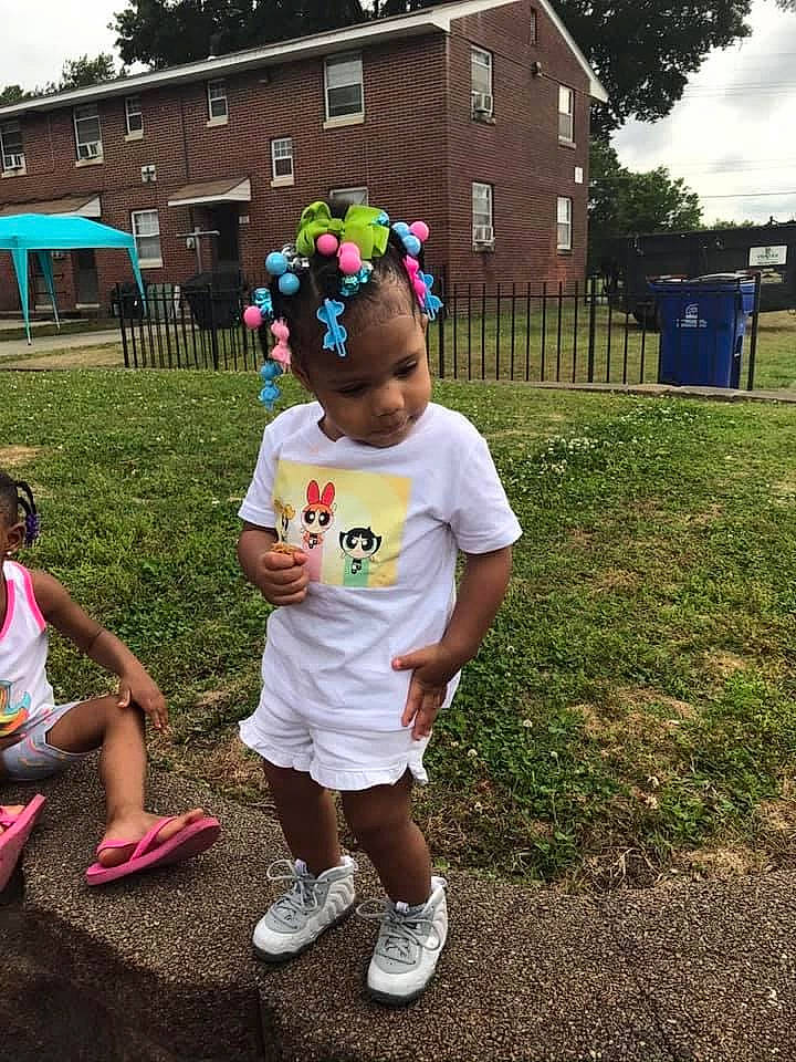 Maddy is registered to the contest to win money with this photo: baby_toddler_clothing, child, clothing, cottage, flip_flops, footwear, hair_accessory, house, person, pink, shoe, shorts, sneakers, spring, style, summer, t_shirt, toddler, umbrella, walking_shoe