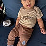 baby, child, infant, sitting, clothing, pants, shirt, face, eyes, sock, furniture, blue_chair, indoor, expression, cute, person, portrait, young, head, hands