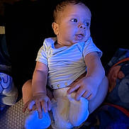 Drevonte is registered to the contest to win money with this photo: baby, infant, child, blue_light, sitting, diaper, onesie, blanket, indoor, cute, portrait, human, skin, hand, foot, expression, head, face, eyes, soft_lighting