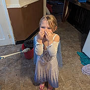 Wil joined the competition — help win amazing prizes! child, girl, dress, princess, flip_flops, floor, tile, mop, bucket, kitchen, wall, door, laundry, playful, hands, face, blonde, indoor, smile, home