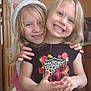 Ama is registered to the contest to win money with this photo: child, children, smiling, hugging, indoor, kitchen, casual_clothing, hat, long_hair, blonde, happy, person, portrait, two_people, jeans, tshirt, cabinet, door, floor, light