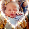 baby, sleeping, infant, heart_shape, sparkle, light_effect, cozy, warm_tone, blanket, clothing, peaceful, portrait, cute, hands, face, newborn, soft_light, indoor, resting, toddler