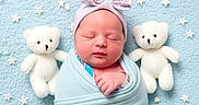Hazel is registered to the contest to win money with this photo: newborn, baby, swaddled, blue_blanket, headband, bow, sleeping, teddy_bear, plush, crescent_moon, stars, soft_texture, cute, infant, portrait, lying_down, decorative_background, child, peaceful, adorable