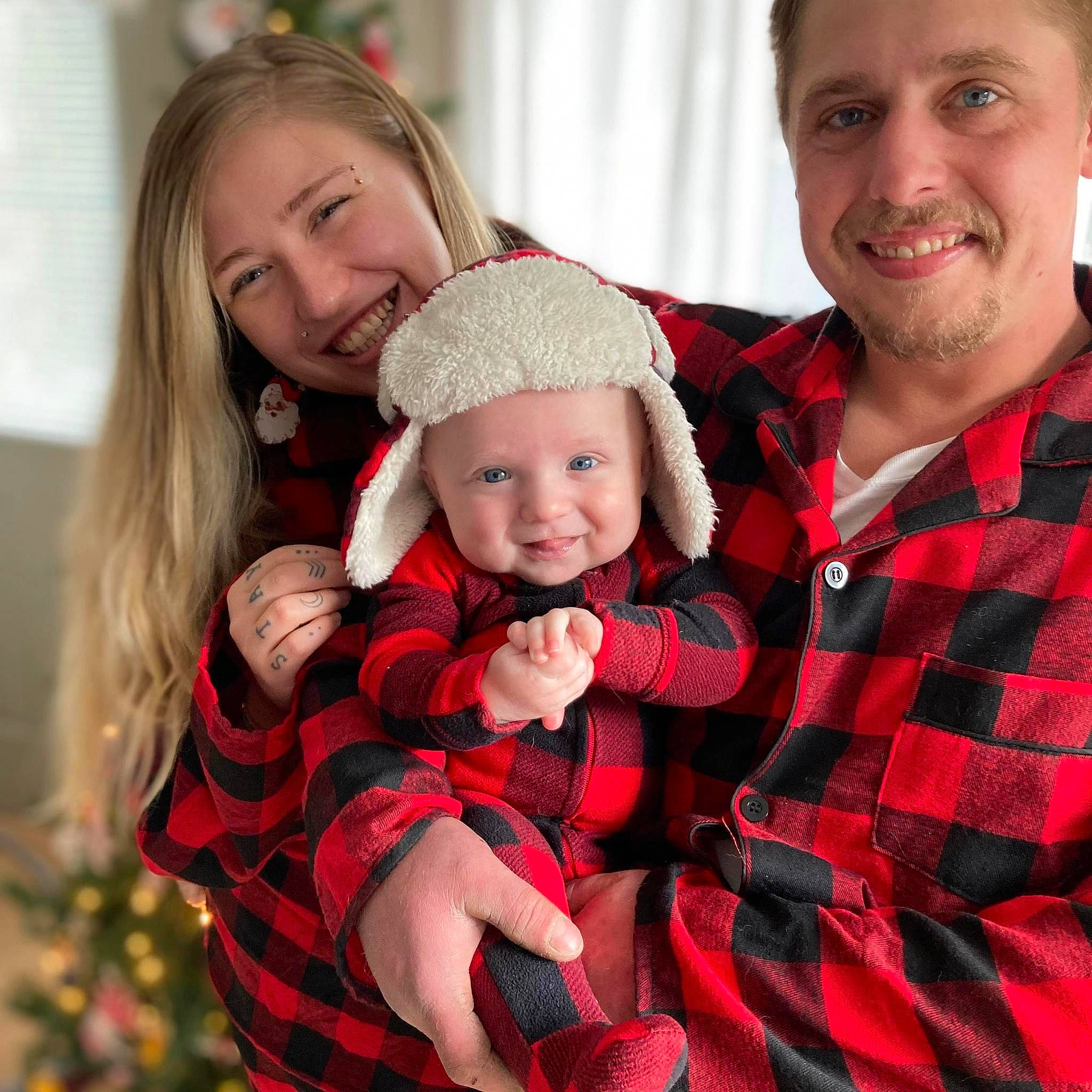 Ziggy is registered to the contest to win money with this photo: baby_toddler_clothing, cap, child, christmas, christmas_decoration, christmas_eve, christmas_ornament, event, fun, happy, headwear, holiday, joy, lap, pattern, person, plaid, red, santa_claus, sleeve