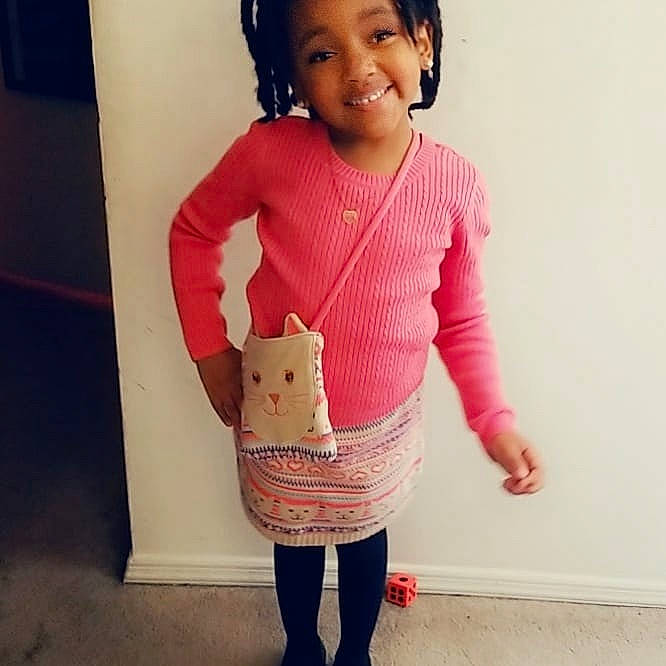 Nia is registered to the contest to win money with this photo: beauty, child, clothing, face, fashion, footwear, head, joint, joy, knee, leg, neck, outerwear, person, pink, shoulder, skin, sleeve, sweater, tights