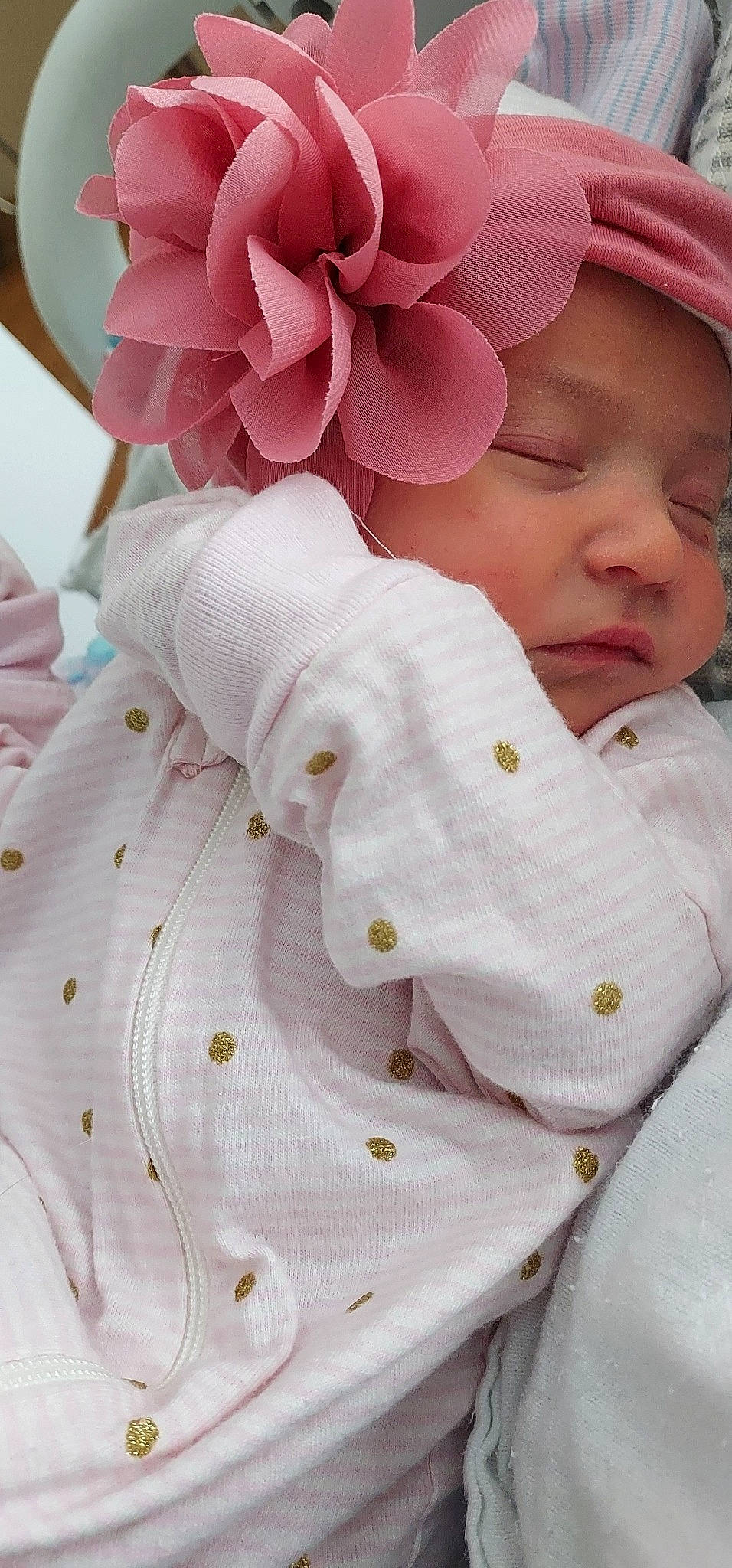 Penelope is registered to the contest to win money with this photo: baby, baby_sleeping, baby_toddler_clothing, cap, comfort, flower, gesture, happy, headwear, linens, magenta, pattern, peach, people_in_nature, person, petal, pink, plant, sleeve, textile