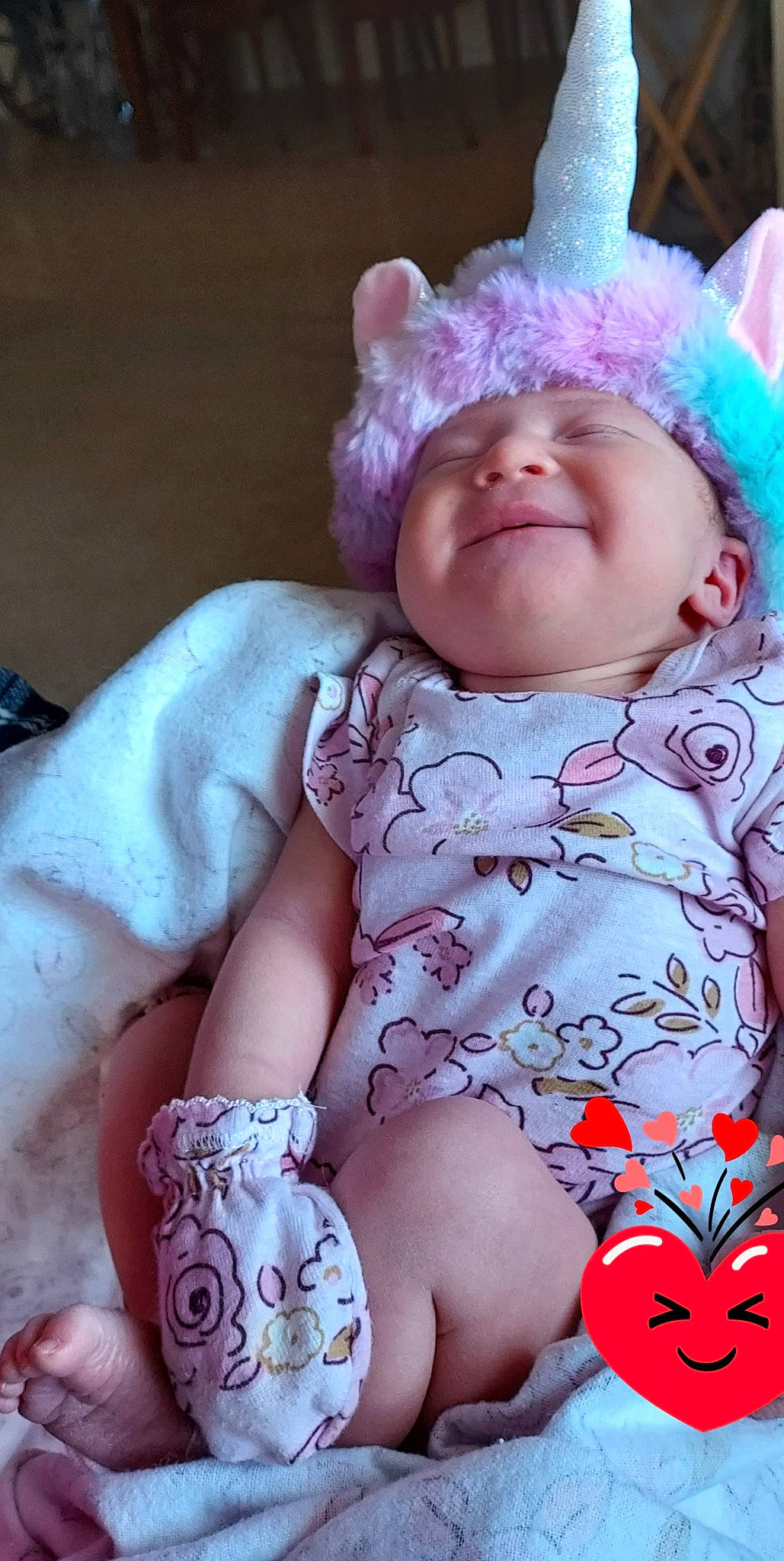 Penelope is registered to the contest to win money with this photo: arm, baby_toddler_clothing, cap, cheek, dress, eye, face, facial_expression, head, human_body, iris, lip, outerwear, person, pink, purple, skin, sleeve, smile, textile