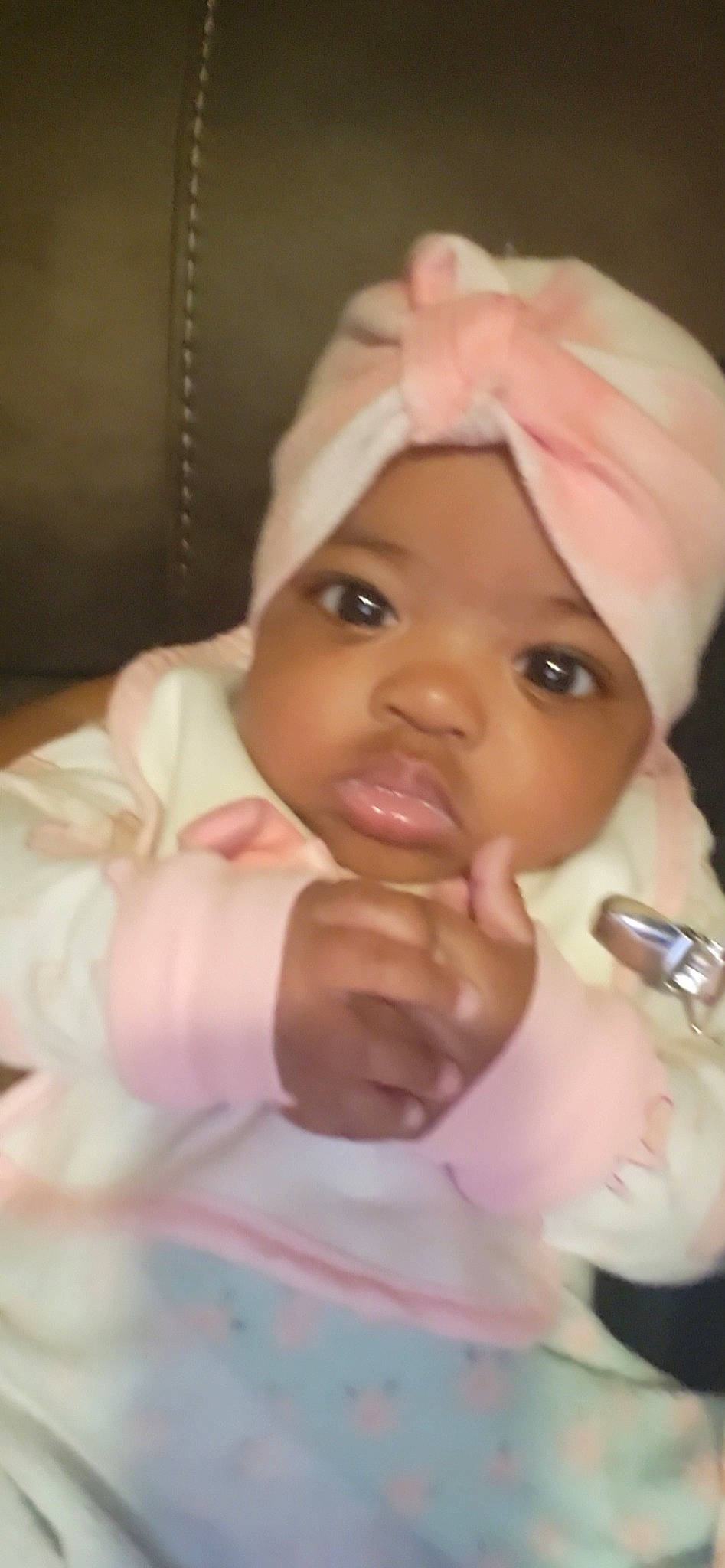 Hartley is registered to the contest to win money with this photo: baby, cheek, chin, ear, eye, eyebrow, eyelash, face, finger, gesture, happy, headwear, human_body, iris, lip, mouth, nose, person, pink, skin