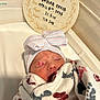 newborn, baby, sleeping, blanket, hat, bow, hospital, birth_announcement, footprint_pattern, infant, swaddled, bed, crib, face, closed_eyes, skin, person, cute, rest, hospital_room