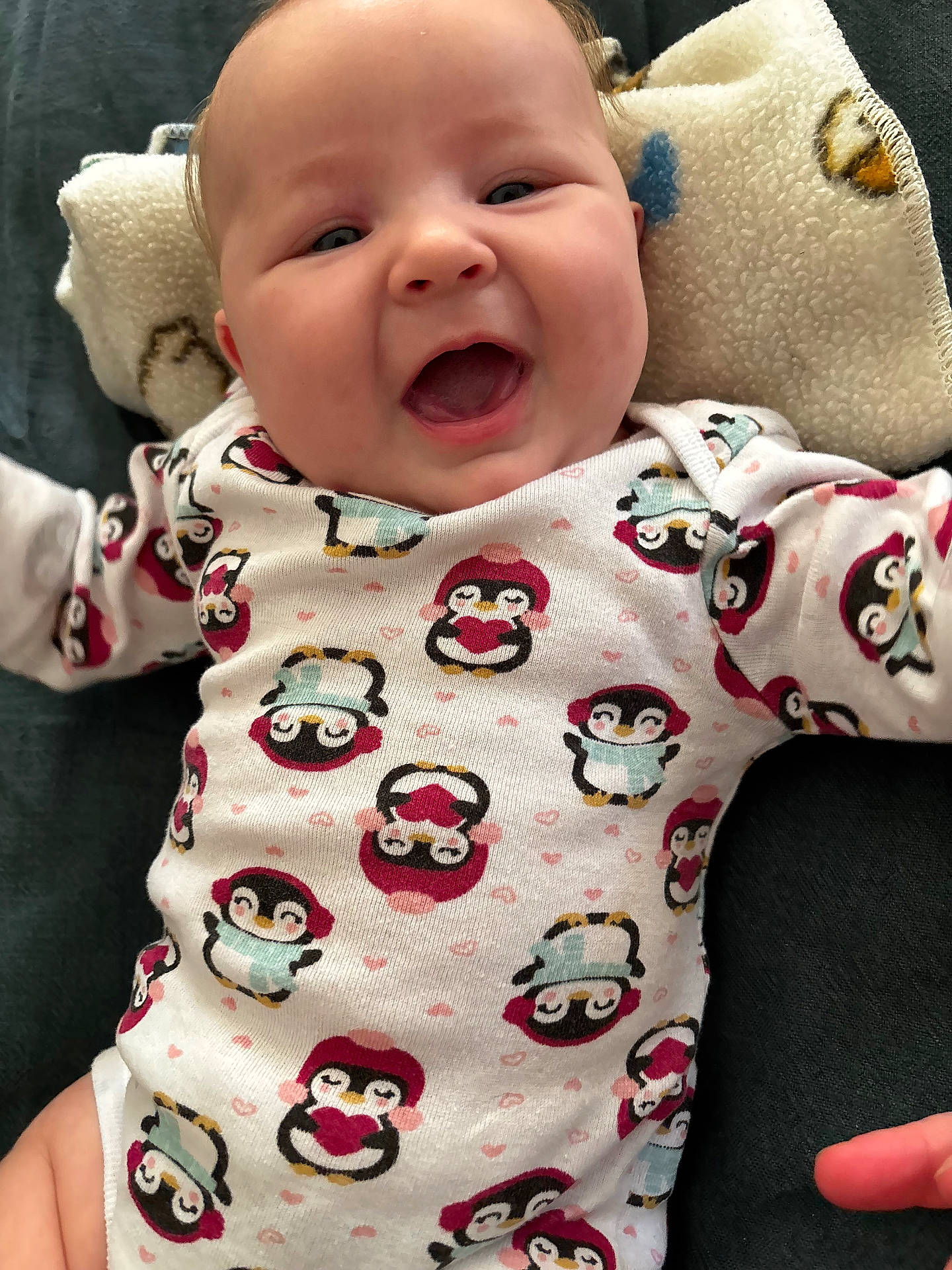 Aspyn is registered to the contest to win money with this photo: animal, baby, babylaughing, bird, clothing, cushion, dress, face, happy, head, homedecor, laughing, newborn, pajamas, penguin, person, photography, portrait, smile, t_shirt