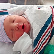 Jameson is registered to the contest to win money with this photo: newborn, baby, sleeping, infant, blanket, hospital, cap, swaddled, cute, peaceful, face, mouth_open, closed_eyes, soft, skin, child, portrait, resting, white_clothing, indoor