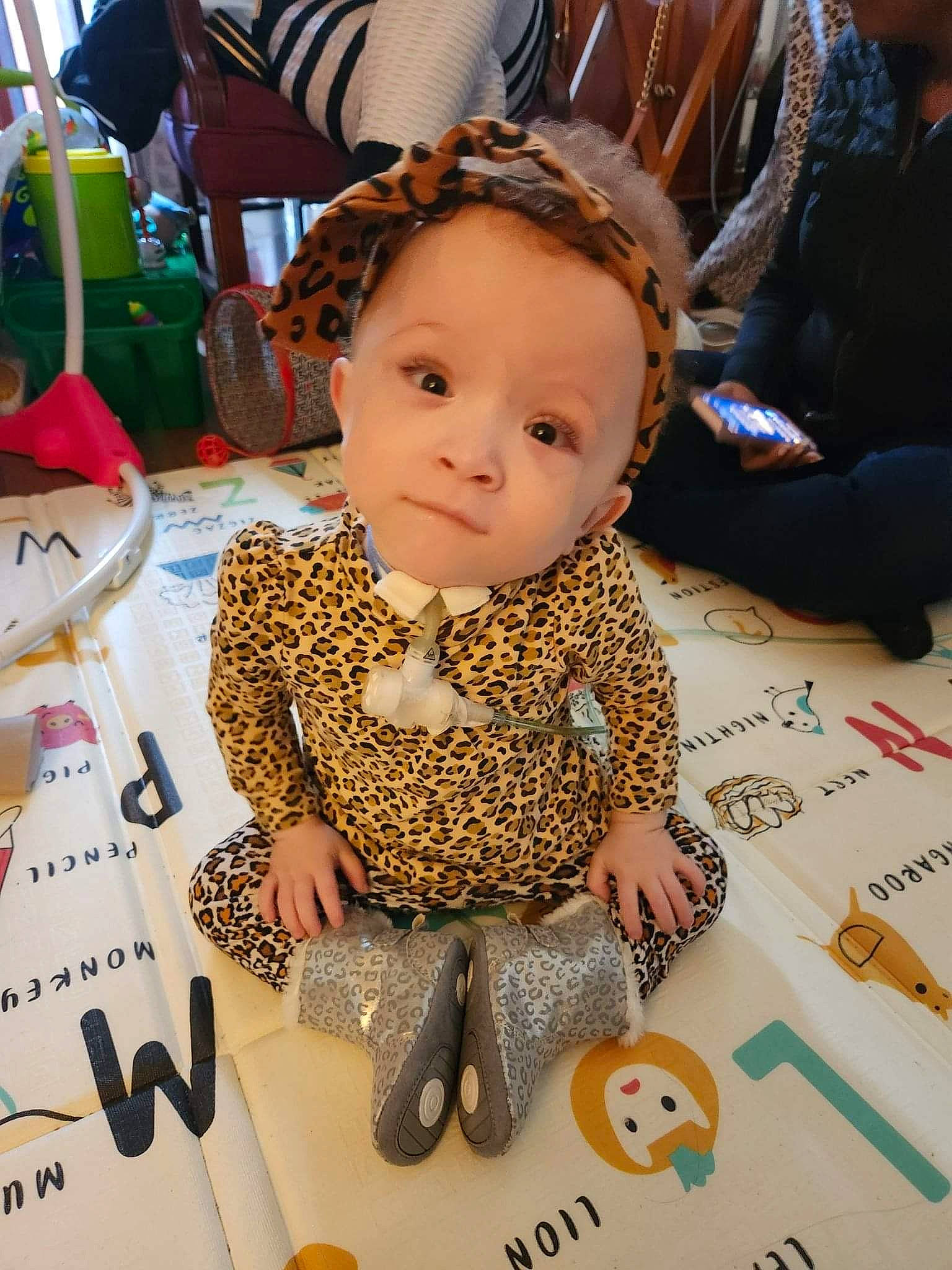 Serenitie is registered to the contest to win money with this photo: art, baby, baby_toddler_clothing, chair, cheek, child, event, flooring, font, fun, happy, pattern, person, room, sitting, toddler