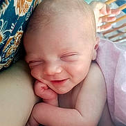 Gabriel a rejoint le concours — aidez-le/la à gagner de superbes lots ! baby, newborn, infant, sleeping, smiling, face, head, hand, arm, skin, blanket, crib, patterned_fabric, close_up, portrait, cozy, peaceful, nursery, soft_lighting, cute