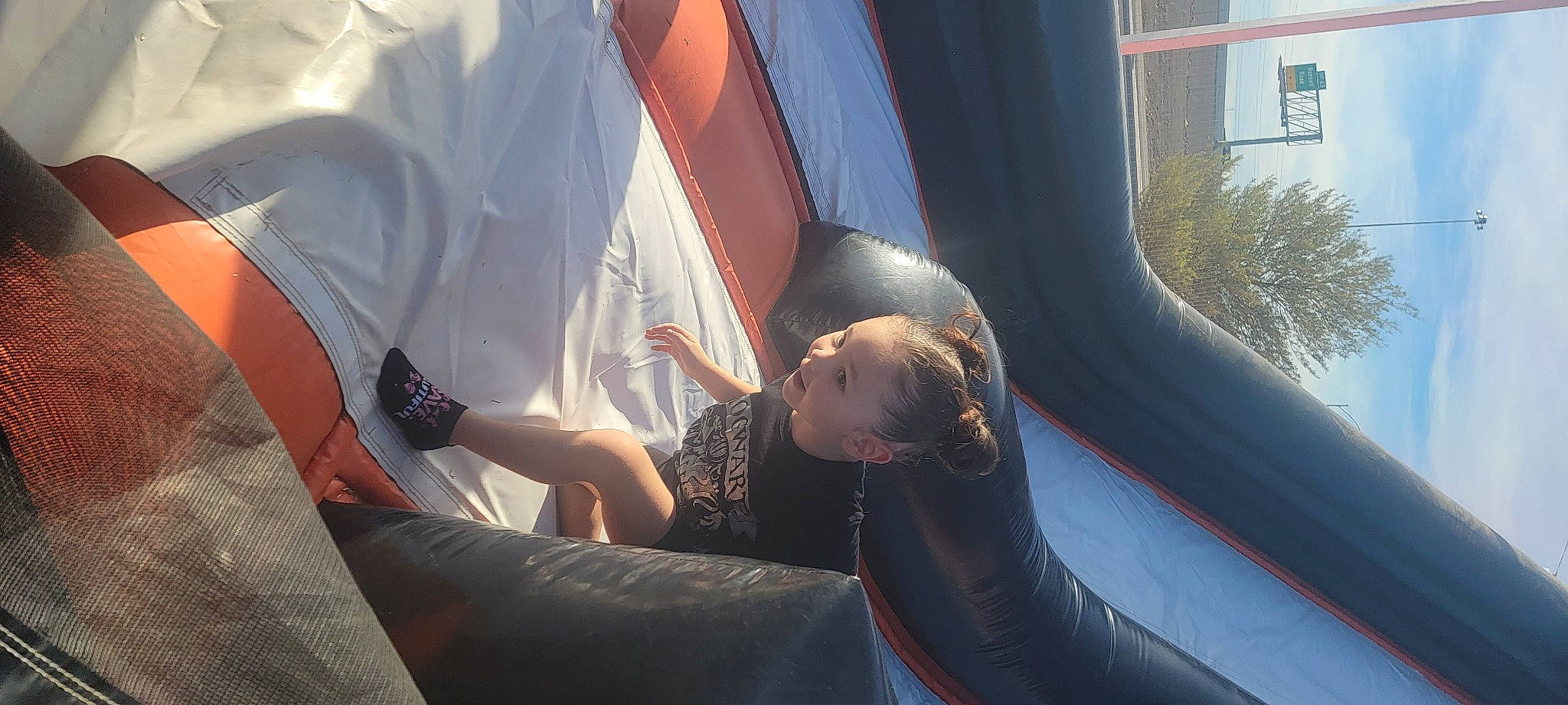 Abby is registered to the contest to win money with this photo: auto_part, automotive_design, comfort, elbow, finger, foot, fun, grass, human_leg, inflatable, knee, leg, leisure, motor_vehicle, person, recreation, sitting, thigh, tree, vehicle_door